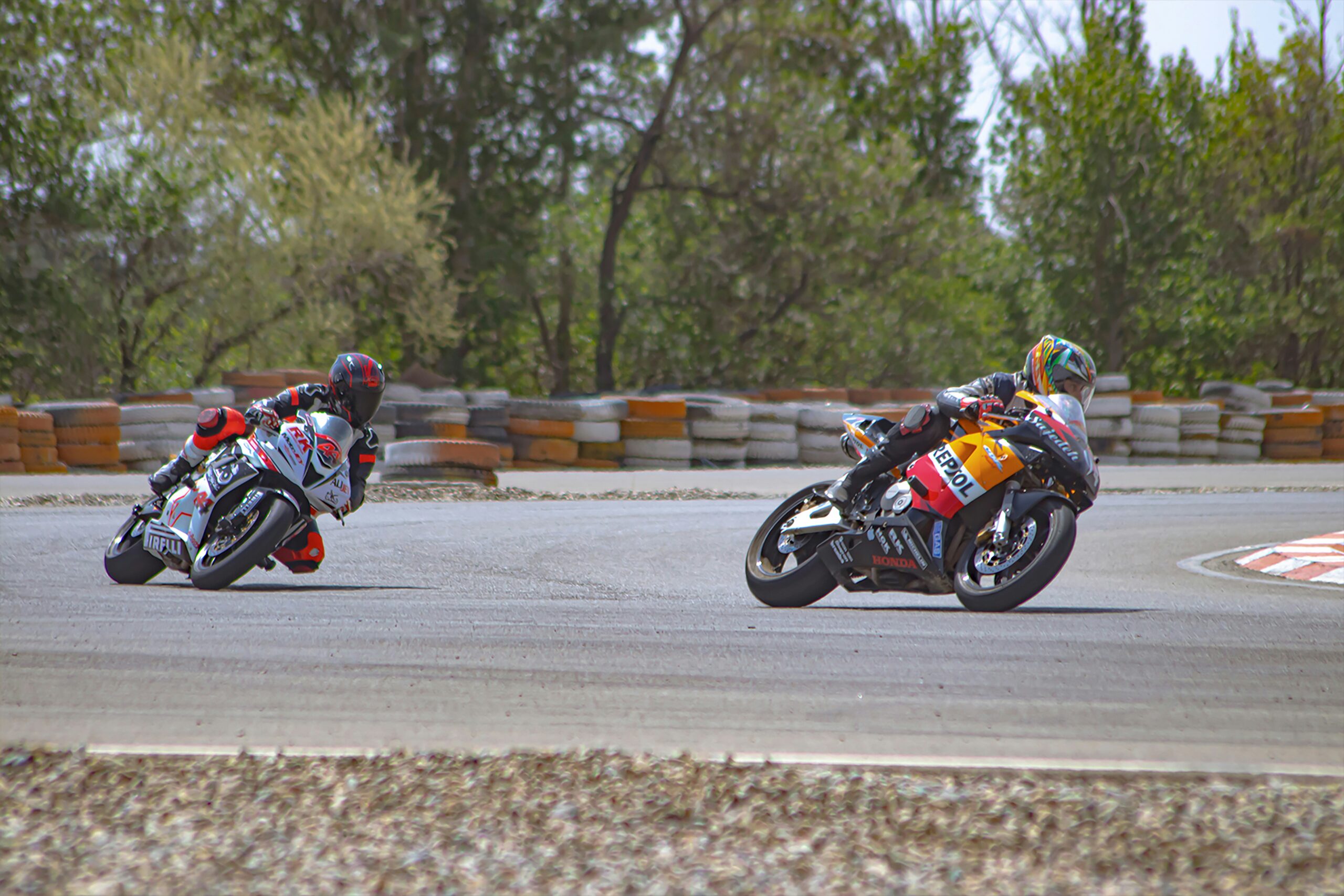 two people riding motorcycles